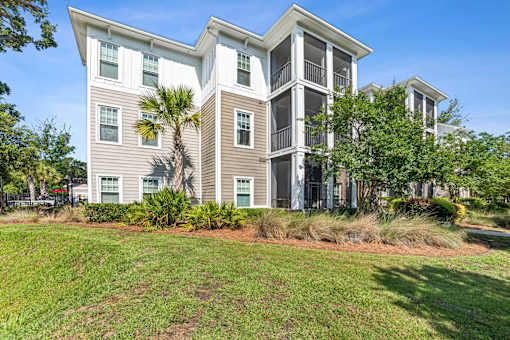 A large two-story building with a balcony on the second floor at Proximity Apartments, South Carolina, 29414