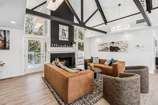 A living room with a fireplace and a brown couch at Park Ridge Estates, Durham, 27713