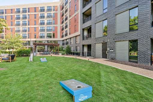 A blue framed box sits on a green lawn.