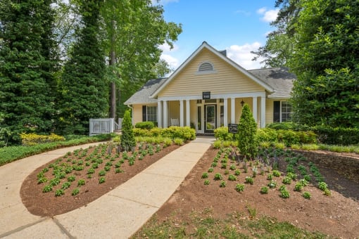 a house with a garden and a walkway in front of it at Clarion Crossing Apartments, PRG Real Estate Management, Raleigh