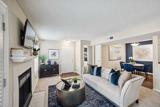A living room with a fireplace and a couch at Willow Ridge Apartments, North Carolina, 28210