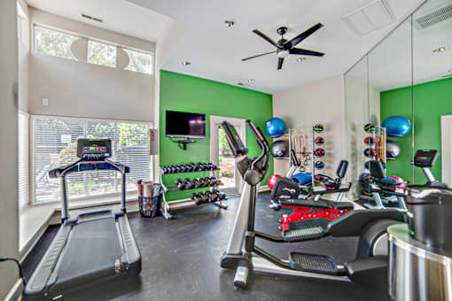 A room with a treadmill and exercise equipment at Beacon Ridge Apartments, PRG Real Estate Management, Greenville, 29615