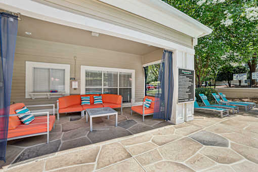 A patio with a table and chairs is shown at Beacon Ridge Apartments, PRG Real Estate Management, Greenville, 29615
