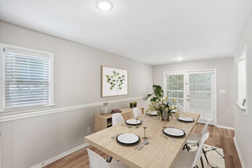 a dining room with a wooden table and chairs at Lake Johnson Mews, Raleigh, 27606