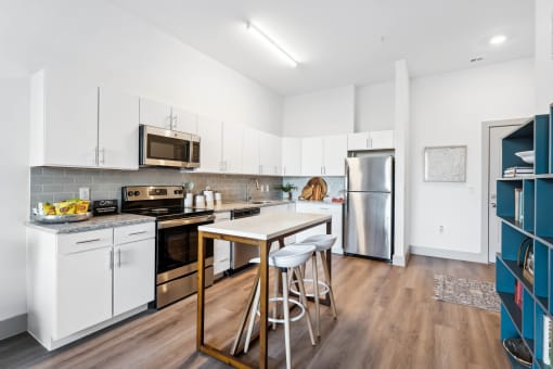 a kitchen with white cabinetry and stainless steel appliances at The Point Apartments on 38th, Norfolk, Virginia