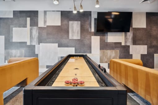 a ping pong table in a game room with a television  at The Box, Richmond
