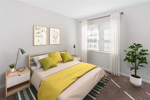 A bedroom with a bed, nightstand, and a plant at Rivers Landing Apartments, Virginia, 23666