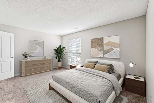 A bedroom with a large bed and a wooden dresser at Park Ridge Estates, Durham, 27713