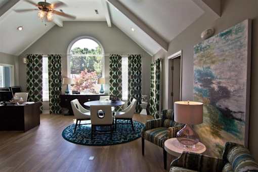 A room with a ceiling fan and a painting on the wall at Clarion Crossing Apartments, PRG Real Estate Management, Raleigh