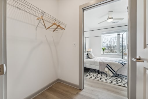 a bedroom with white walls and hardwood floors at The Waterford At Rocketts Landing Apartments, PRG Real Estate, Richmond, Virginia