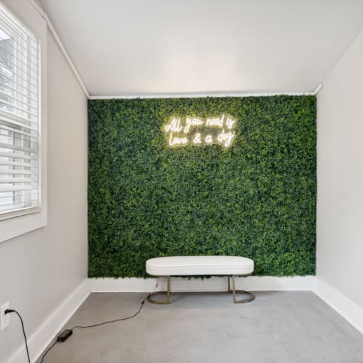 a living wall with a white bench and a table