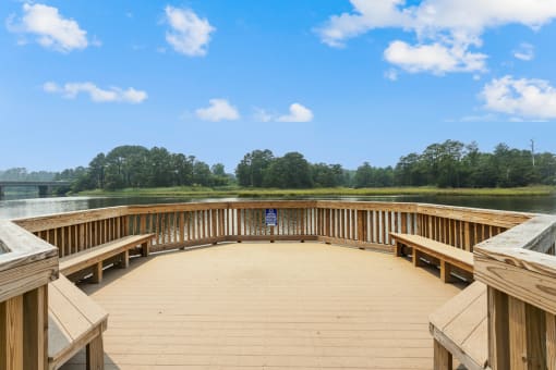 a circular deck with benches overlooking a lake at Linkhorn Bay Apartments, Virginia Beach 23451