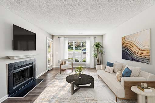 A living room with a fireplace and a painting on the wall at Park Ridge Estates, Durham, 27713