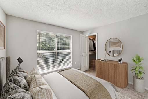 A bedroom with a bed, a dresser, and a mirror at Beacon Ridge Apartments, PRG Real Estate Management, Greenville, 29615