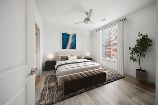 A bedroom with a large bed and a ceiling fan at Circ Apartments, Virginia
