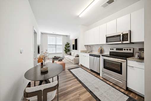 A modern kitchen with a dining table and chairs at Circ Apartments, Virginia