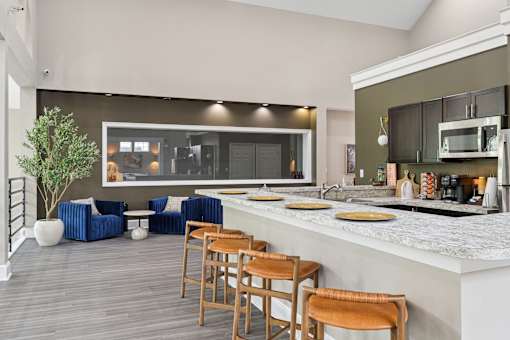 A modern kitchen with a bar area and seating.