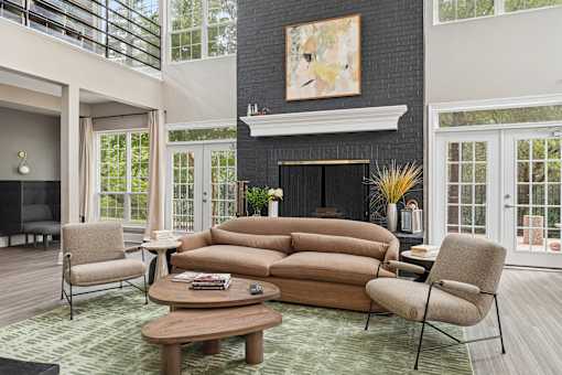 A living room with a fireplace and a painting above it.