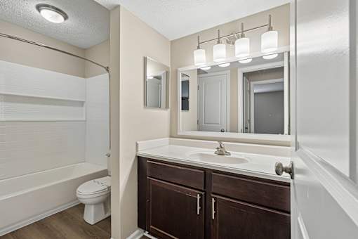 A bathroom with a white sink and a toilet.