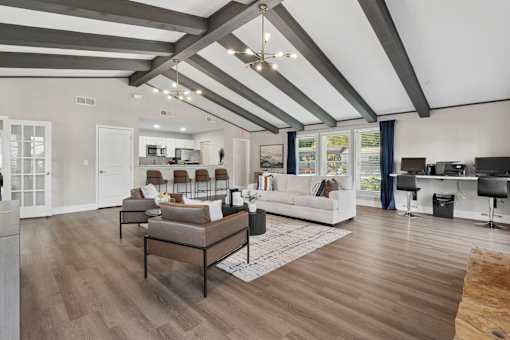 A modern living room with a white couch and a coffee table.