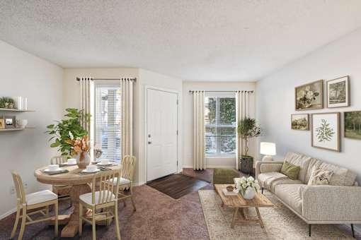 A living room with a dining table and chairs at The Falls Apartments in Raleigh NC