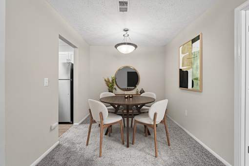 Dedicated dining area with seating for four and open access to kitchen