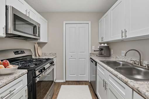 Updated kitchen with white shaker cabinets, stainless steel appliances and ample counter space