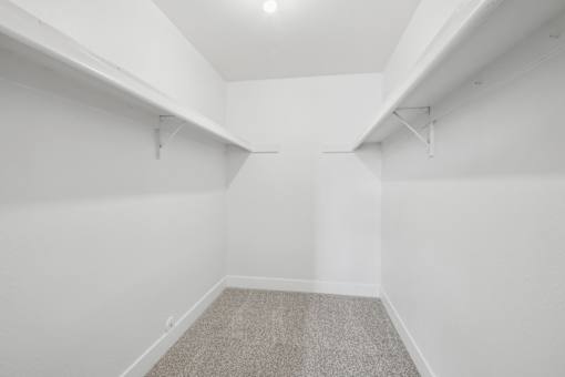 A room with white walls and a carpeted floor.
