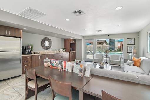A modern kitchen with a dining table and chairs.