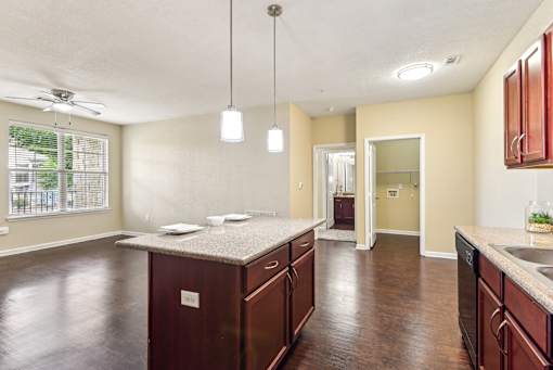 A kitchen with brown cabinets and a countertop at Overlook at Stone Oak Park Apartments, San Antonio