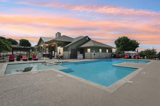 Evening View of Pool Clubhouse Fireplace Lounge Outside at Overlook at Stone Oak Park Apartments, San Antonio, 78258