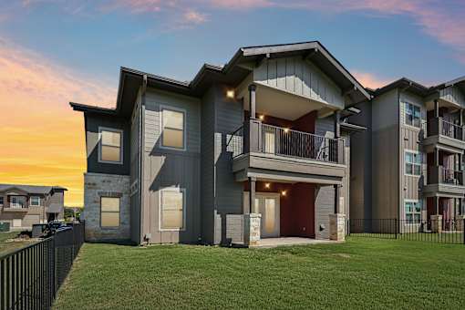 A modern two-story house with a balcony and a garage.