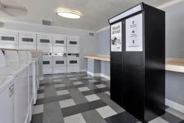 A laundry room with a black and white checkered floor. at North Mountain Apartments, Arizona, 85020