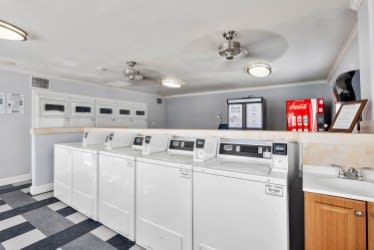 A row of washing machines in a laundry room. at North Mountain Apartments, Phoenix, AZ, 85020