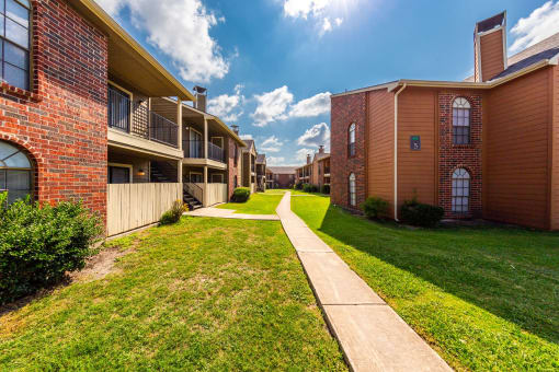 Wide Walkway Between Apartment Buildings at Oaks of Westlakes Apartments, San Antonio, TX