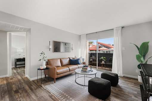 A living room with a brown leather couch and a coffee table.