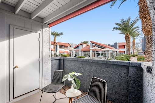 A patio with a table and chairs