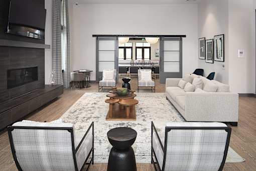 a clubhouse with white furniture and a fireplace