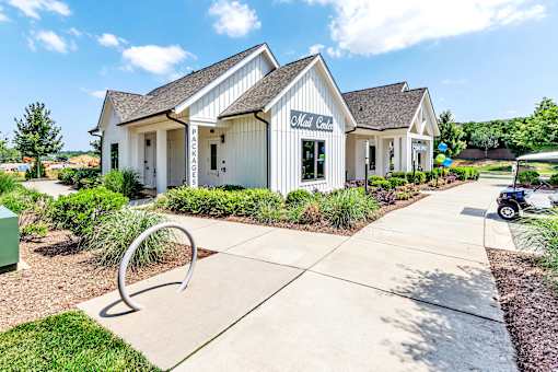 an exterior view of a white building with a sidewalk