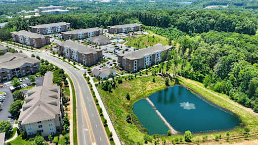an aerial view of a city with buildings and a lake