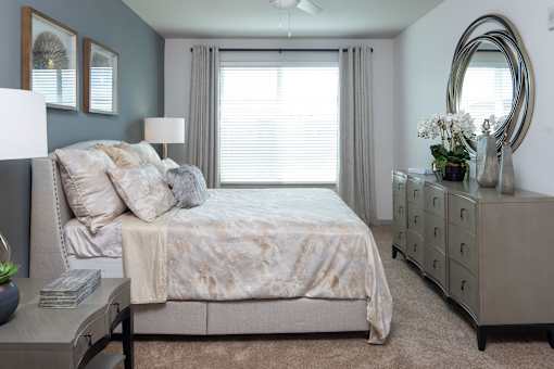 Spacious bedroom with large window and dresser at Avli At Crosstown Center Apartments, TAMPA, 33619