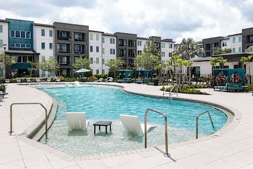 Swimming pool with tanning ledge and apartment buildings at Avli At Crosstown Center Apartments, Florida, 33619