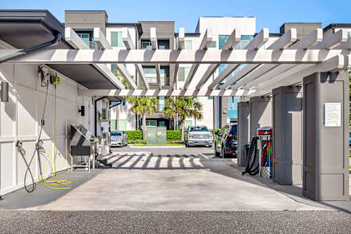 Covered ev charging station with pergola design at Avli At Crosstown Center Apartments, TAMPA, FL 33619