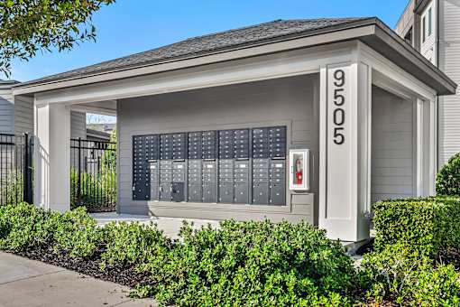 Mail with package lockers and address sign at Avli At Crosstown Center Apartments, TAMPA