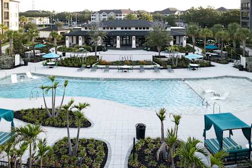 Resort style pool with clubhouse and lounge seating at Avli At Crosstown Center Apartments, TAMPA, FL