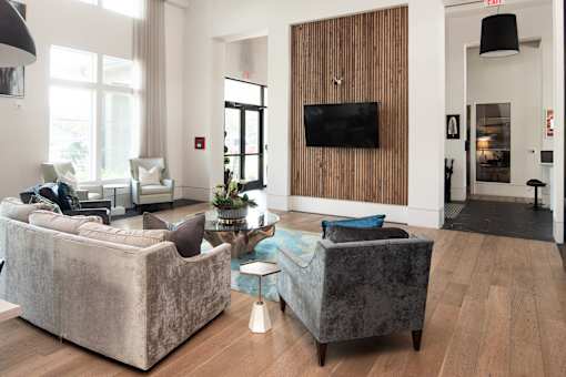 Clubhouse lounge with wood accent wall and television at Avli At Crosstown Center Apartments, Florida, 33619