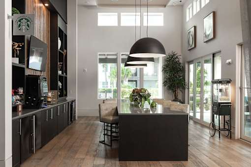 Clubhouse coffee bar with modern pendant lighting at Avli At Crosstown Center Apartments, TAMPA, Florida