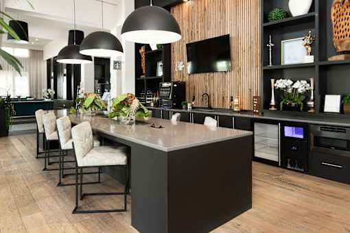 Modern kitchen island with pendant lights and bar seating at Avli At Crosstown Center Apartments, TAMPA