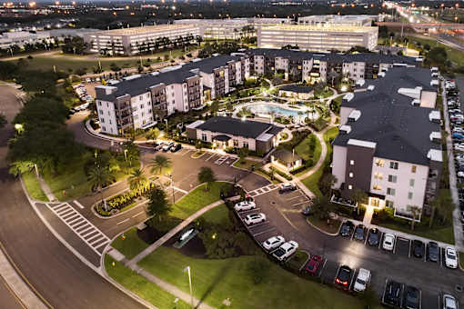 Aerial view of apartment community with courtyard and parking at Avli At Crosstown Center Apartments, TAMPA, 33619