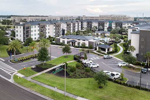 Aerial view of apartment buildings and community entrance at Avli At Crosstown Center Apartments, TAMPA